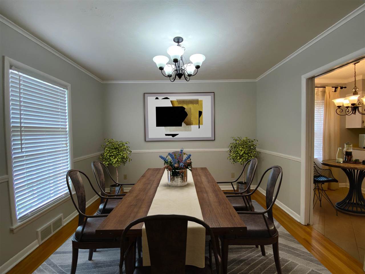 5588 Milford Road Memphis, TN 38120 - Photo 2 of 15 a dining room with furniture potted plants and wooden floor