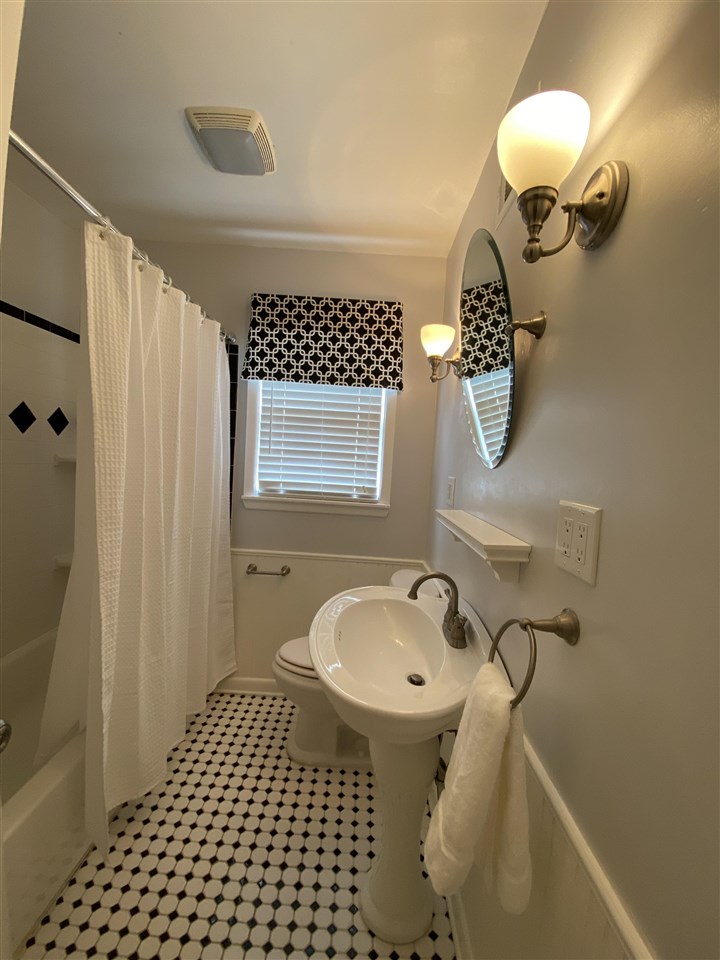 5588 Milford Road Memphis, TN 38120 - Photo 12 of 15 a bathroom with a sink a toilet and shower