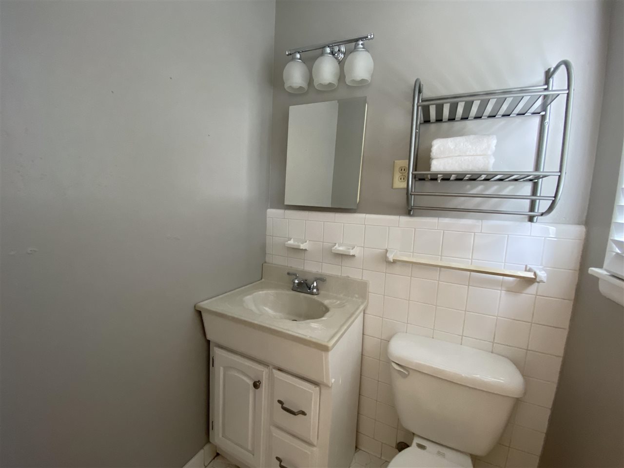 5588 Milford Road Memphis, TN 38120 - Photo 13 of 15 a bathroom with a toilet sink and mirror