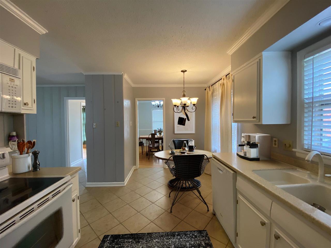 5588 Milford Road Memphis, TN 38120 - Photo 5 of 15 a kitchen with sink refrigerator and cabinets