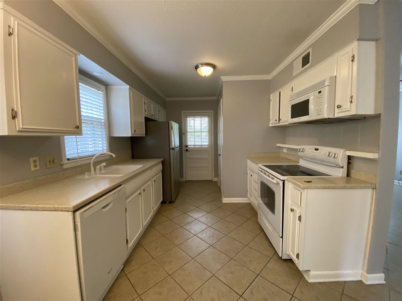 5588 Milford Road Memphis, TN 38120 - Photo 6 of 15 a kitchen with stainless steel appliances a sink and a stove