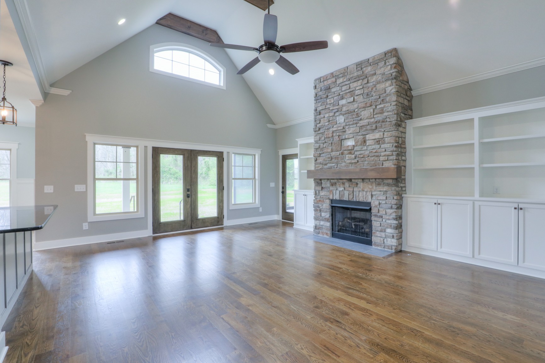 2363 Double Branch Road Columbia, TN 38401 - Photo 4 of 29 an empty room with wooden floor fireplace and windows