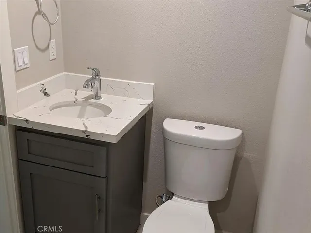 a bathroom with a sink toilet and a mirror