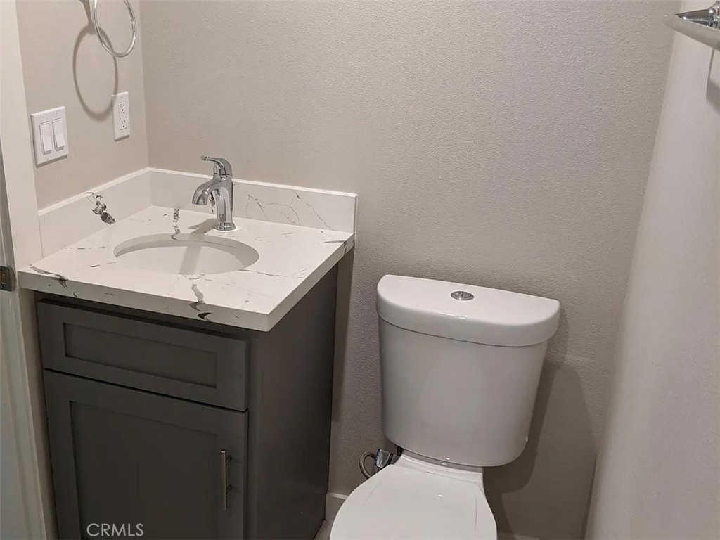 7370 Neo Street Downey, CA 90241 - Photo 26 of 38 a bathroom with a sink toilet and a mirror