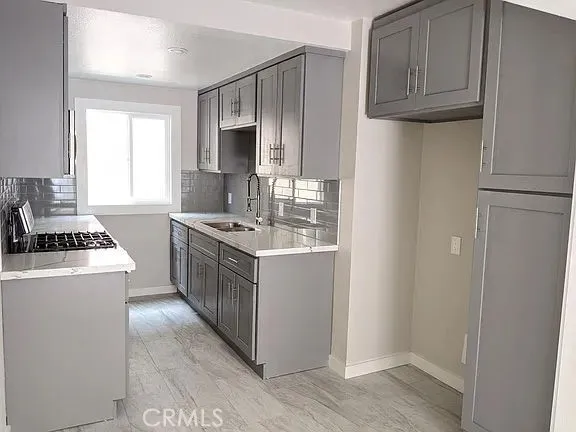 a kitchen with a sink stove and refrigerator