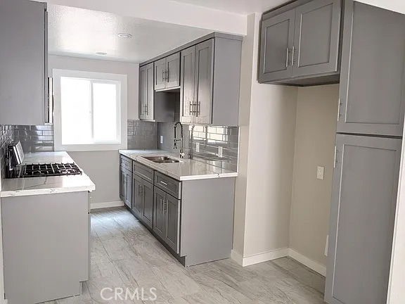7370 Neo Street Downey, CA 90241 - Photo 27 of 38 a kitchen with a sink stove and refrigerator