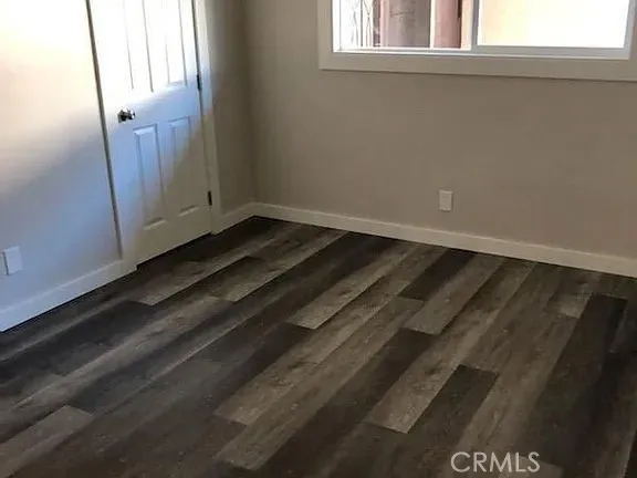 a view of a closet area with wooden floor