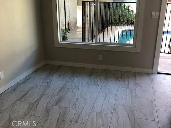 7370 Neo Street Downey, CA 90241 - Photo 36 of 38 an empty room with wooden floor and windows