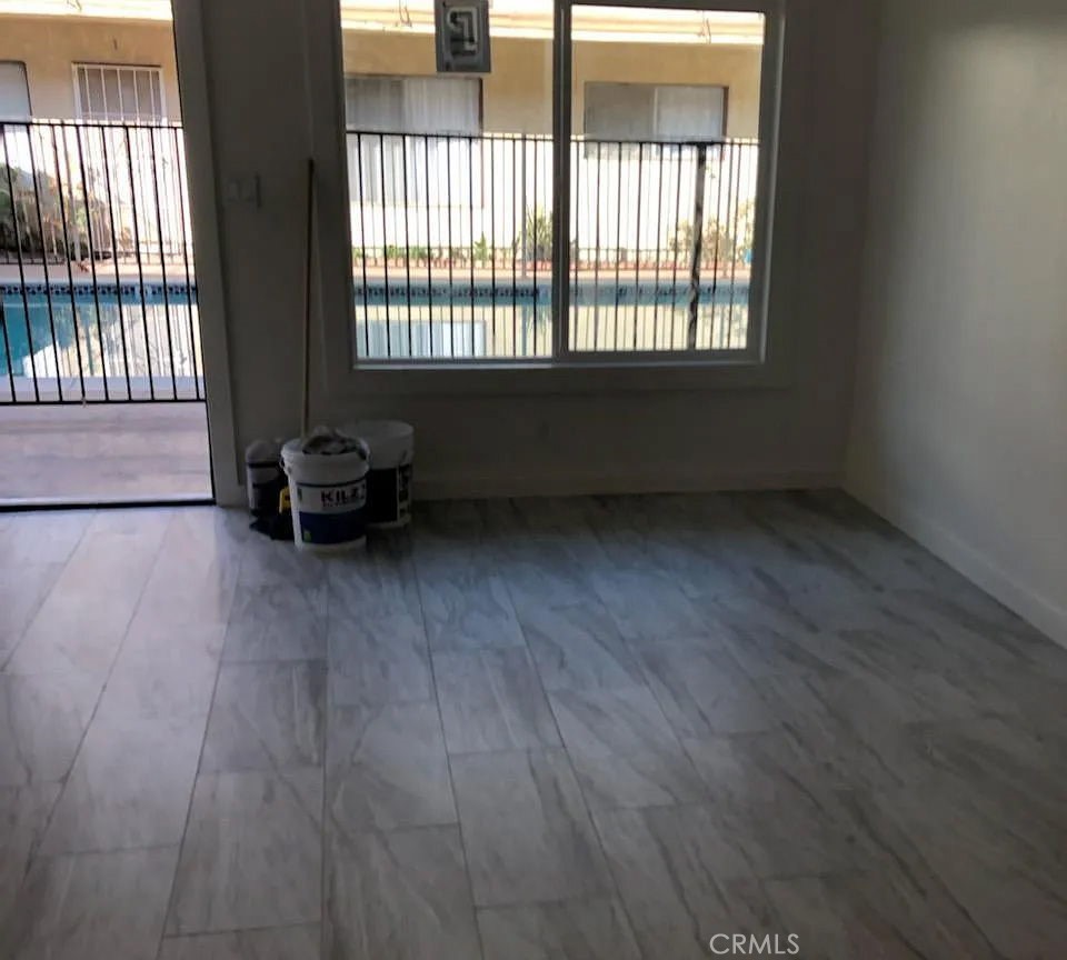 7370 Neo Street Downey, CA 90241 - Photo 38 of 38 an empty room with wooden floor and windows