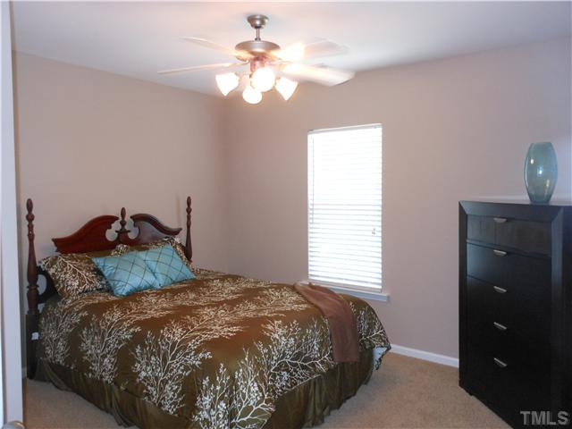 3414 Ranbir Drive Durham, NC 27713 - Photo 12 of 21 a bedroom with a bed and a chandelier