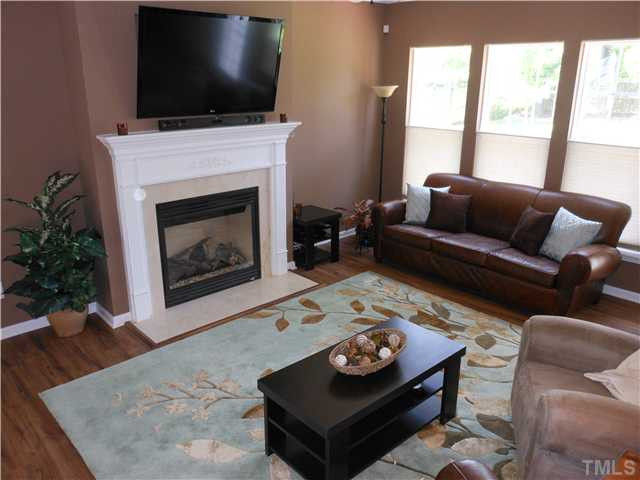 3414 Ranbir Drive Durham, NC 27713 - Photo 21 of 21 a living room with furniture a flat screen tv and a fireplace