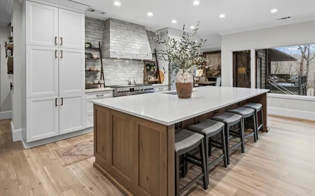 a bathroom with a tub shower and window