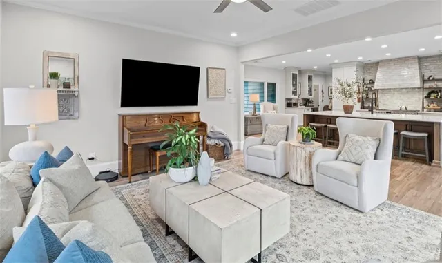a living room with furniture a bookshelf and a large window