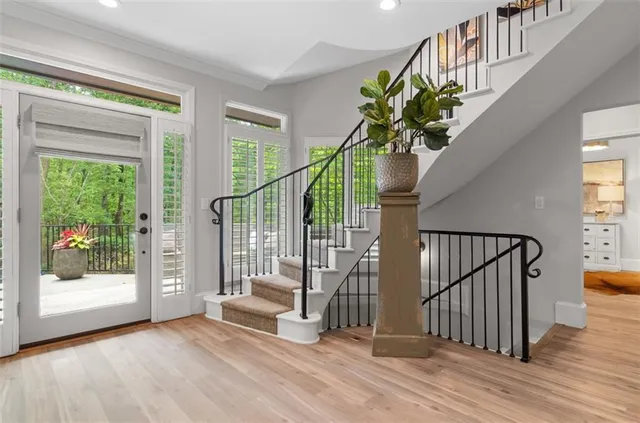 a living room with furniture and a floor to ceiling window