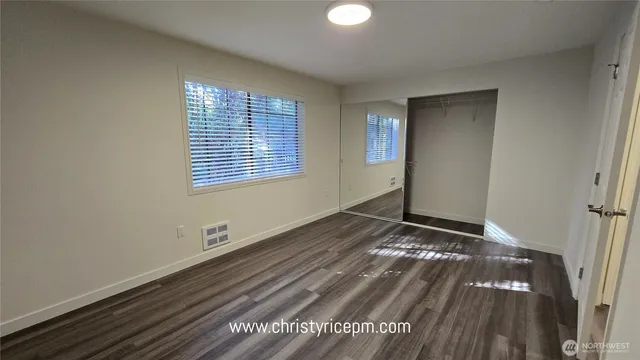 a view of wooden floor and windows in a room