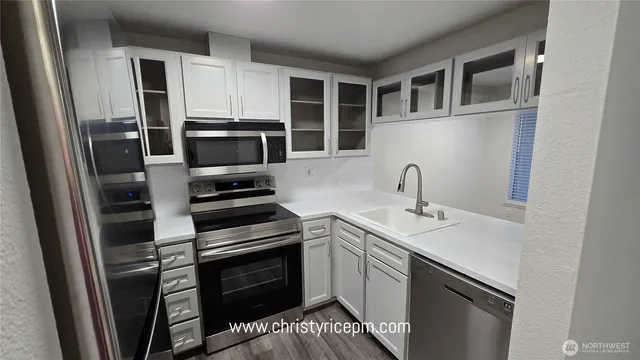 a kitchen with a sink stove and refrigerator
