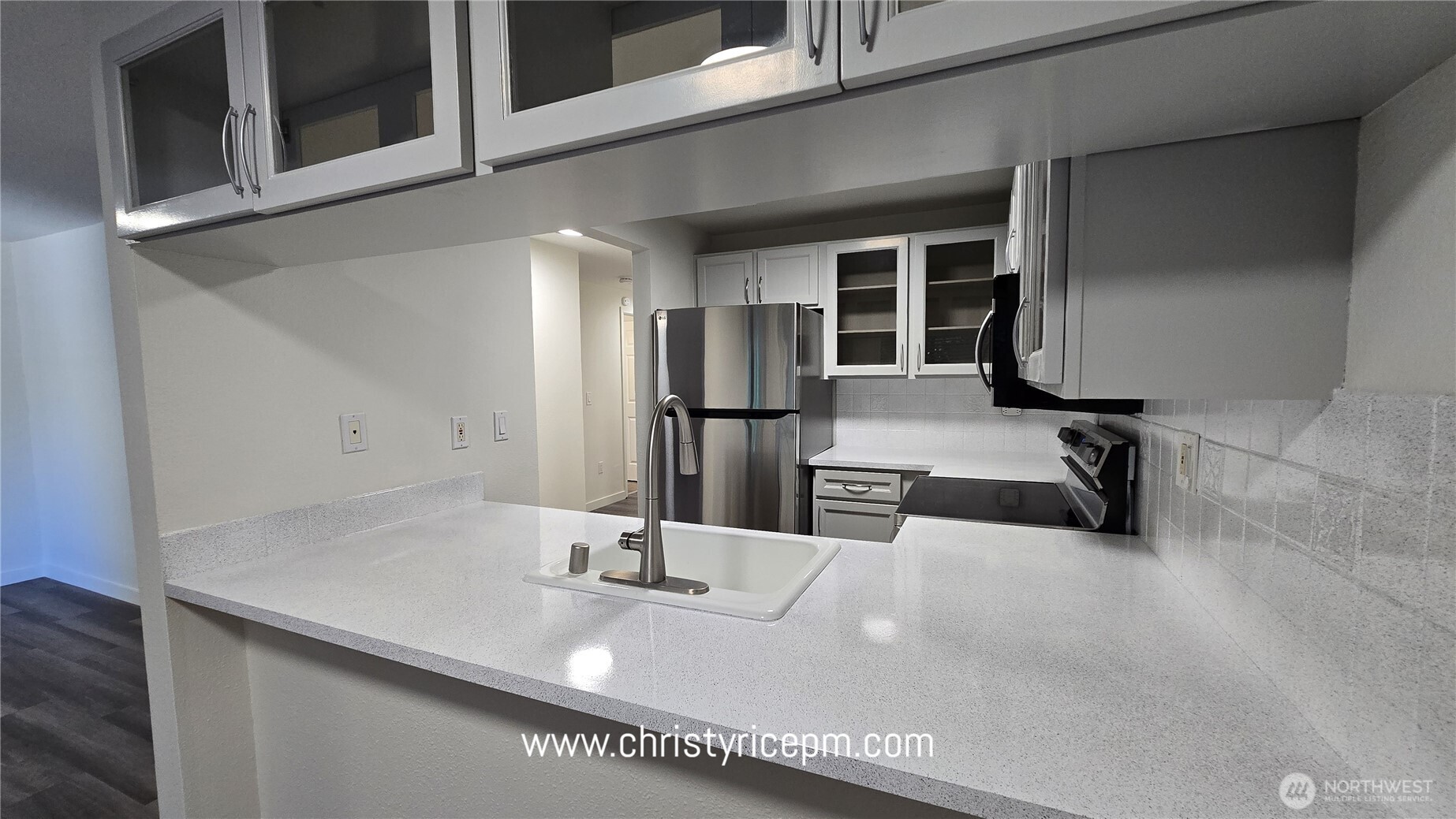 12515 Northeast 116th Street, Unit B23 Kirkland, WA 98034 - Photo 10 of 17 a kitchen with a sink and refrigerator