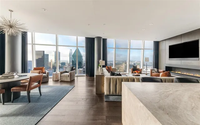 a living room with furniture and large windows