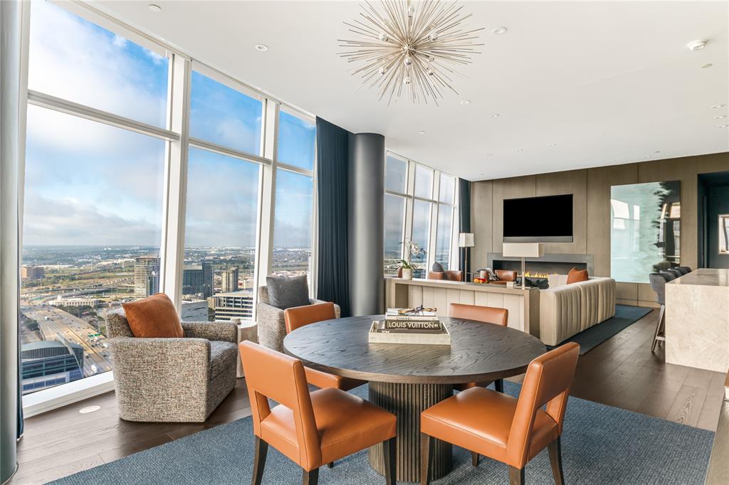 1918 Olive Street, Unit 3403 Dallas, TX 75201 - Photo 18 of 39 a dining room with furniture a large window and a flat screen tv