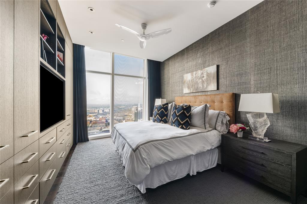 1918 Olive Street, Unit 3403 Dallas, TX 75201 - Photo 21 of 39 a bedroom with bed and a flat tv screen on dresser
