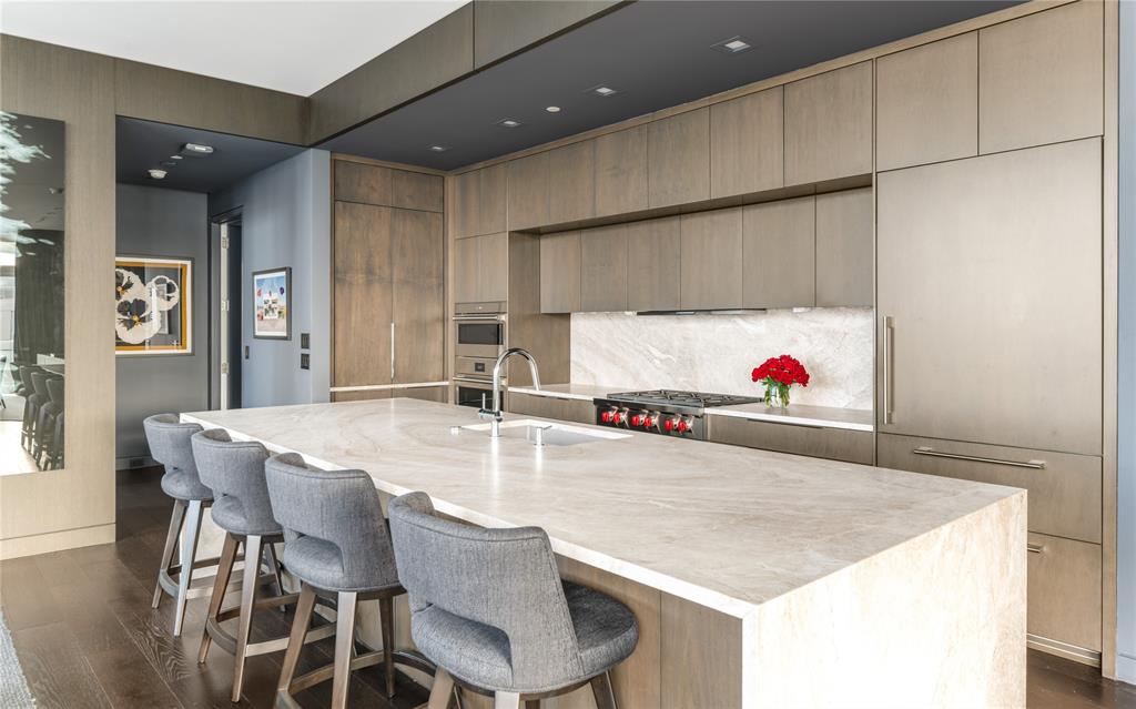 1918 Olive Street, Unit 3403 Dallas, TX 75201 - Photo 5 of 39 a kitchen with a table and chairs in it