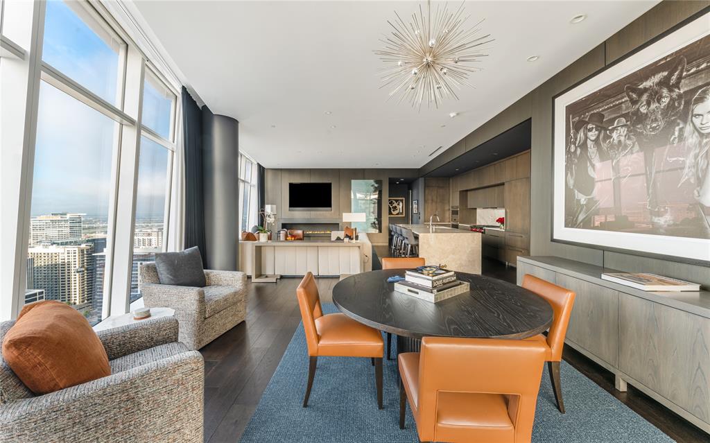 1918 Olive Street, Unit 3403 Dallas, TX 75201 - Photo 10 of 39 a living room with furniture a fireplace and a flat screen tv