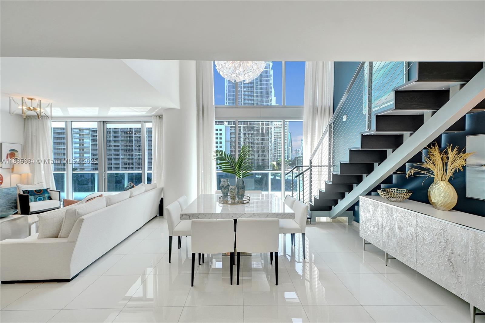 200 Biscayne Blvd Way, Unit 505 Miami, FL 33131 - Photo 1 of 51 a living room with furniture and a large window