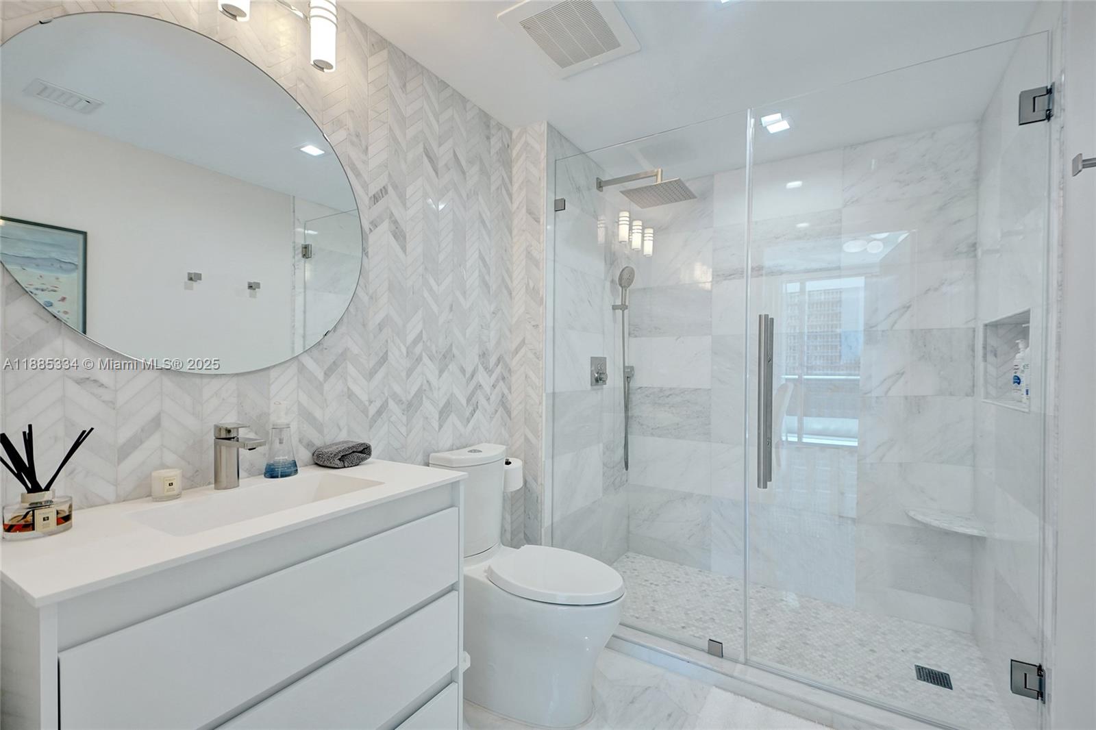 200 Biscayne Blvd Way, Unit 505 Miami, FL 33131 - Photo 11 of 51 a bathroom with a toilet sink and shower