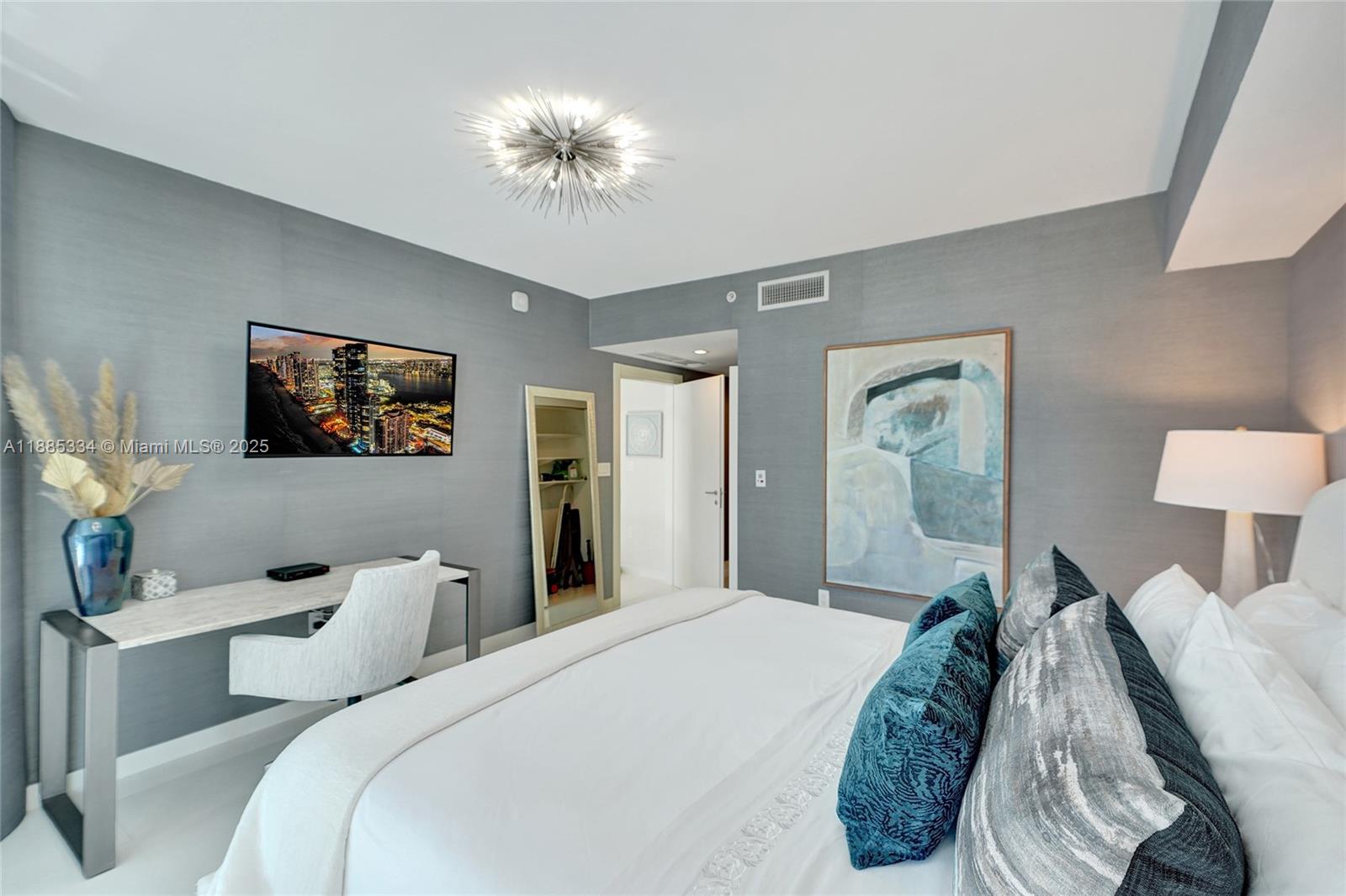 200 Biscayne Blvd Way, Unit 505 Miami, FL 33131 - Photo 22 of 51 a bedroom with bed and a chandelier