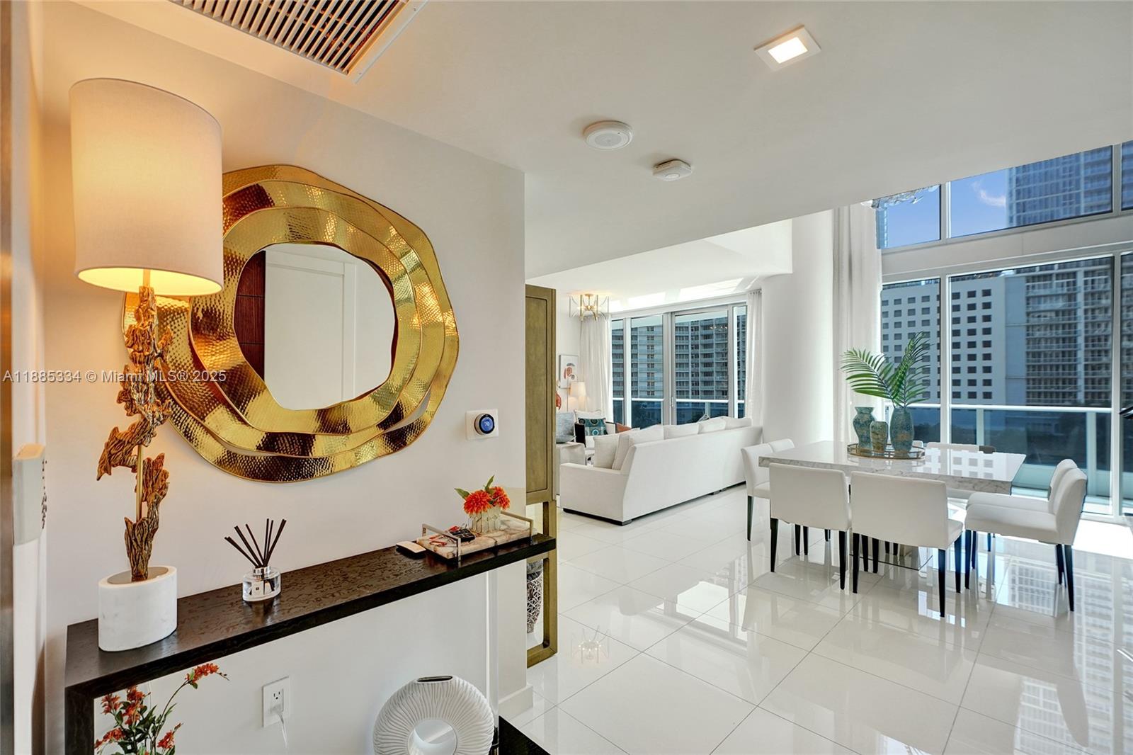 200 Biscayne Blvd Way, Unit 505 Miami, FL 33131 - Photo 30 of 51 a living room with furniture and a mirror