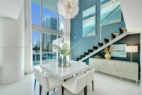 a living room with furniture and a floor to ceiling window