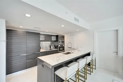 a kitchen with stainless steel appliances a sink and microwave