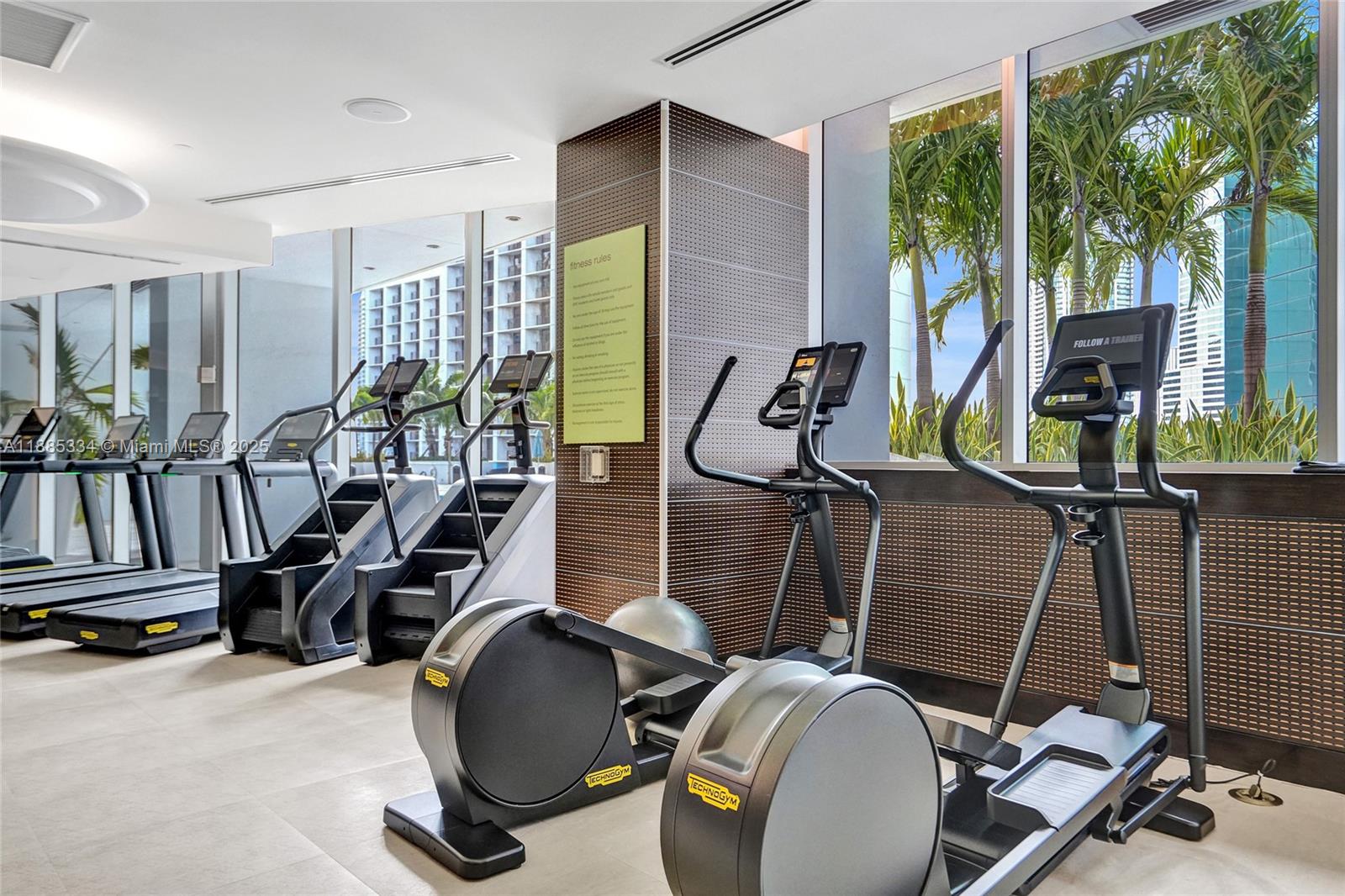 200 Biscayne Blvd Way, Unit 505 Miami, FL 33131 - Photo 47 of 51 a room with gym equipment and windows