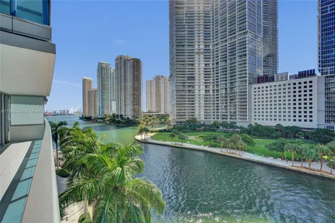 a view of a tall building with a yard and plants