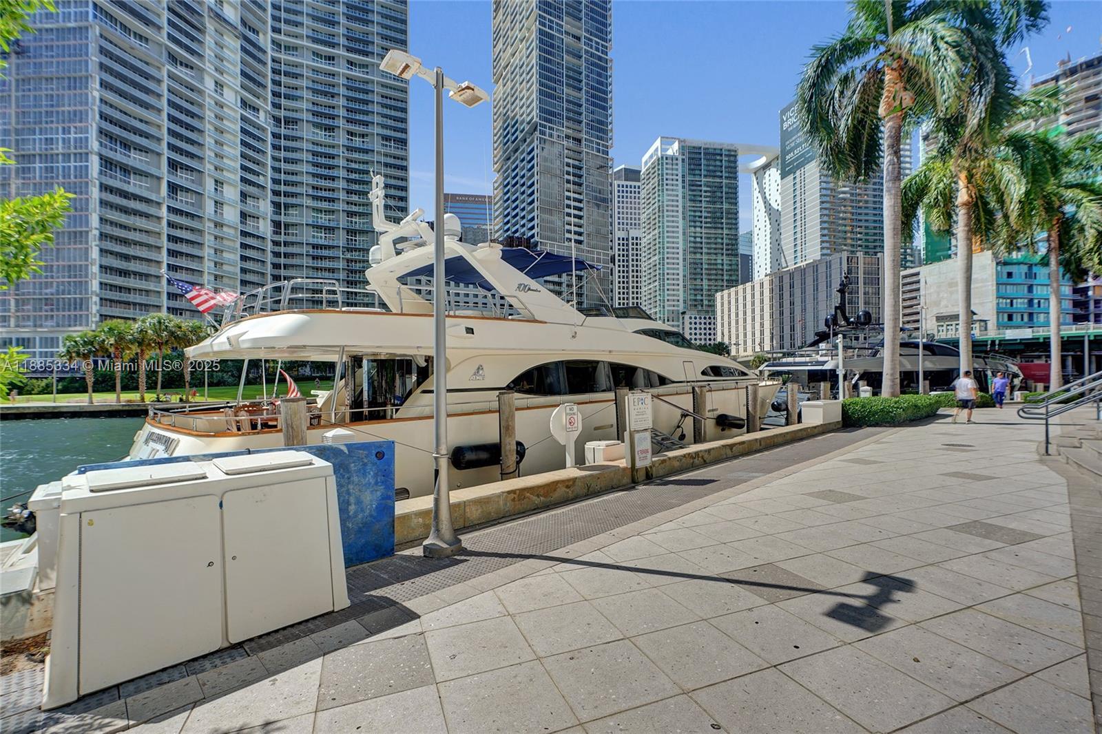 200 Biscayne Blvd Way, Unit 505 Miami, FL 33131 - Photo 8 of 51 a view of a patio with table and chairs under an umbrella with a barbeque grill and plants