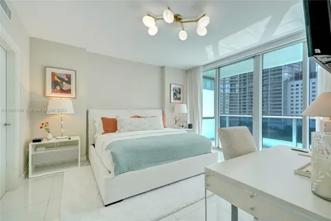 a bedroom with a large bed and a large window