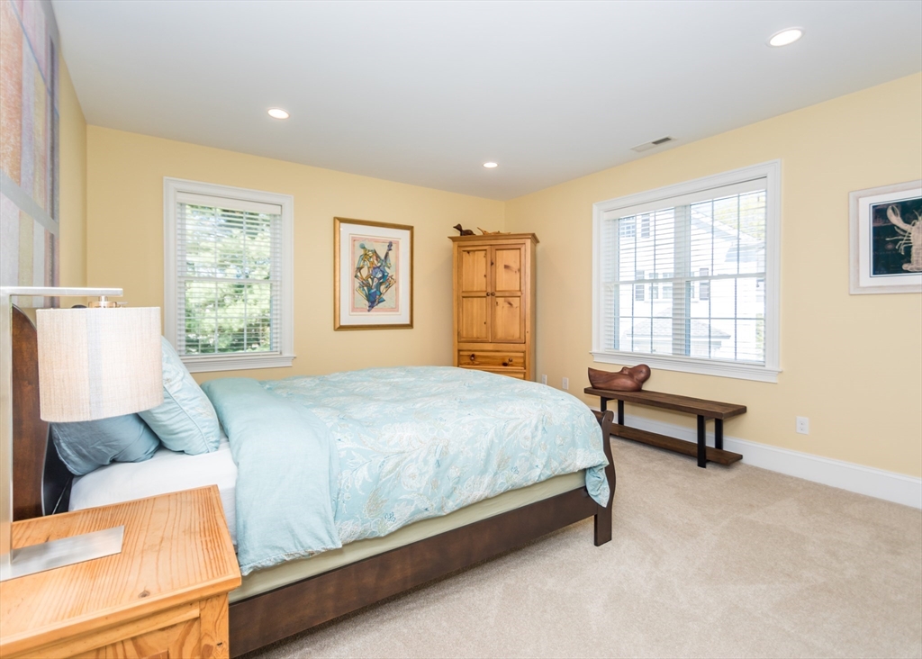 128 Church Street, Unit 2 Waltham, MA 02452 - Photo 19 of 41 a bed room with a bed and a couch