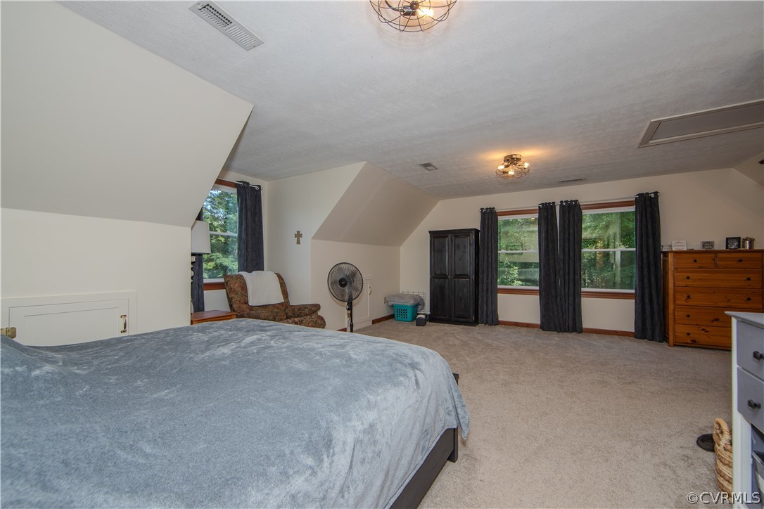 9910 Colemans Lake Road Ford, VA 23850 - Photo 14 of 33 a large bed sitting in a room next to a window