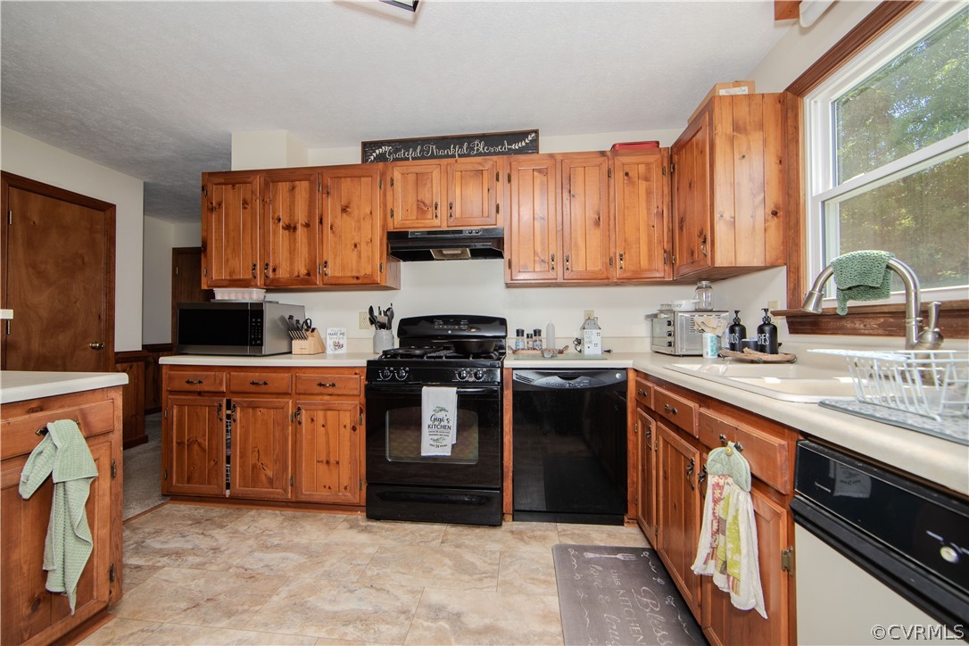 9910 Colemans Lake Road Ford, VA 23850 - Photo 4 of 33 a kitchen with stainless steel appliances granite countertop a stove a sink and a refrigerator