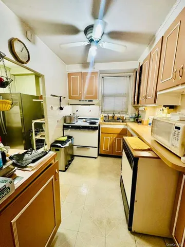 a kitchen with a sink appliances and cabinets