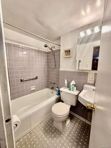 a bathroom with a toilet a sink and bathtub