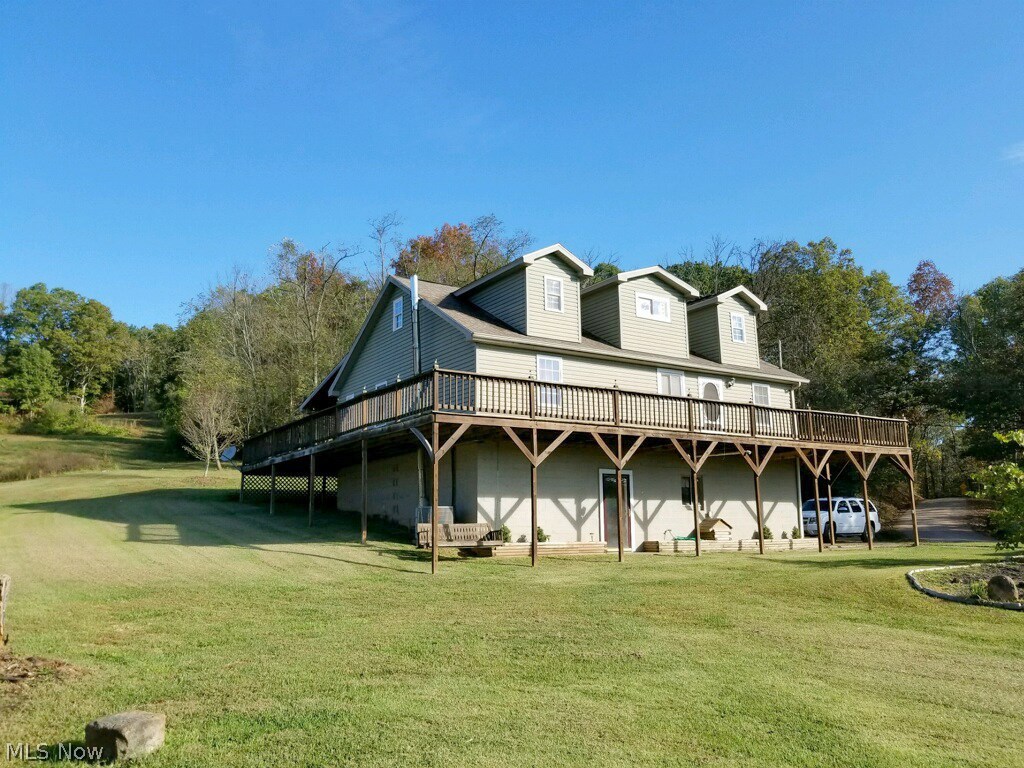 29 Fall Run Road Walker, WV 26180 - Photo 4 of 35 Beautiful yard leading up to the back of the home....as the wrap around porch follows to the back of the home...enjoy the views on a beautiful afternoon swinging on the swing!
