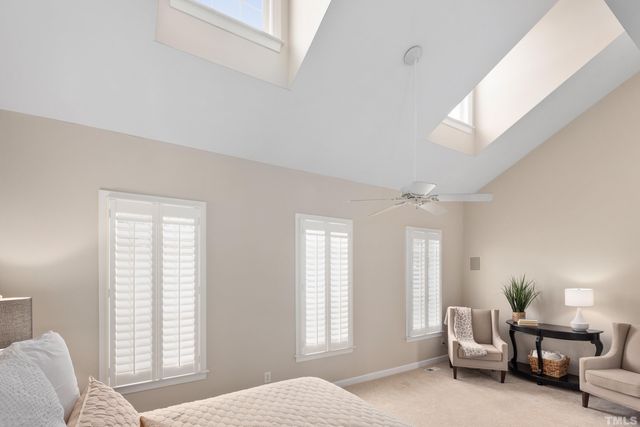 a spacious bedroom with a bed and windows