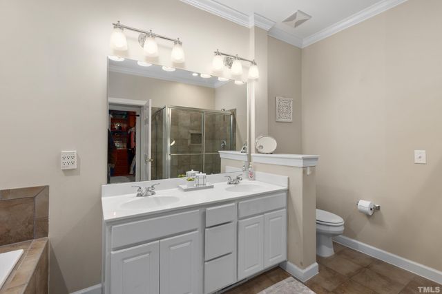 a bathroom with a double vanity sink mirror and toilet