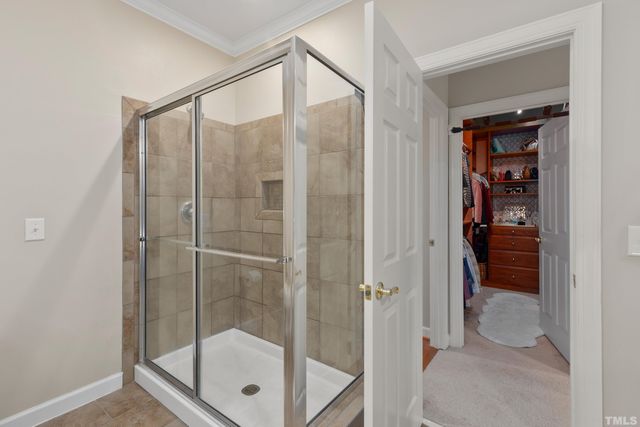 a bathroom that has a glass shower door