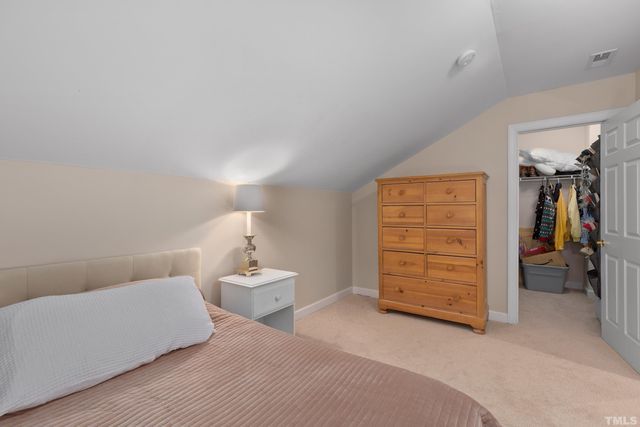 a bedroom with a bed and a chair