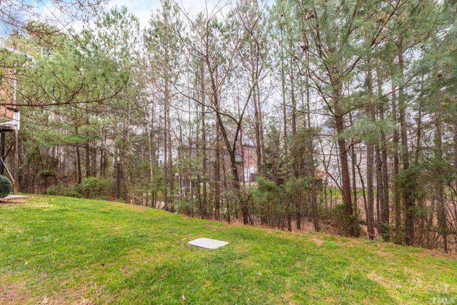 a backyard of a house with large trees