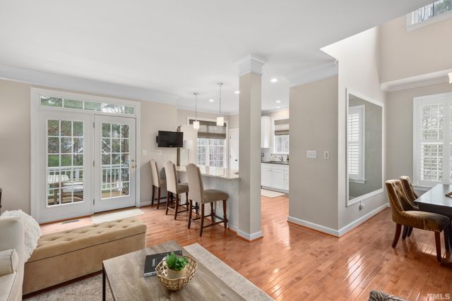 a living room with furniture and floor to ceiling windows