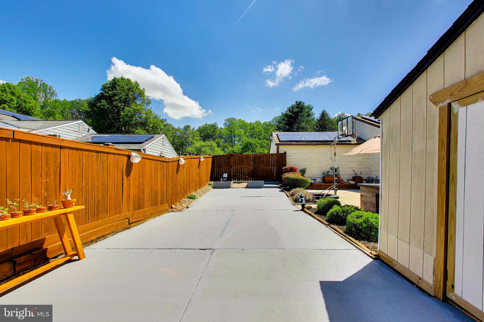 14216 Alderton Road Silver Spring, MD 20906 - Photo 49 of 63 a view of a patio with table and chairs with wooden fence