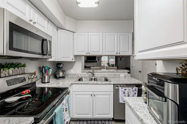 a kitchen with stainless steel appliances granite countertop a stove and cabinets